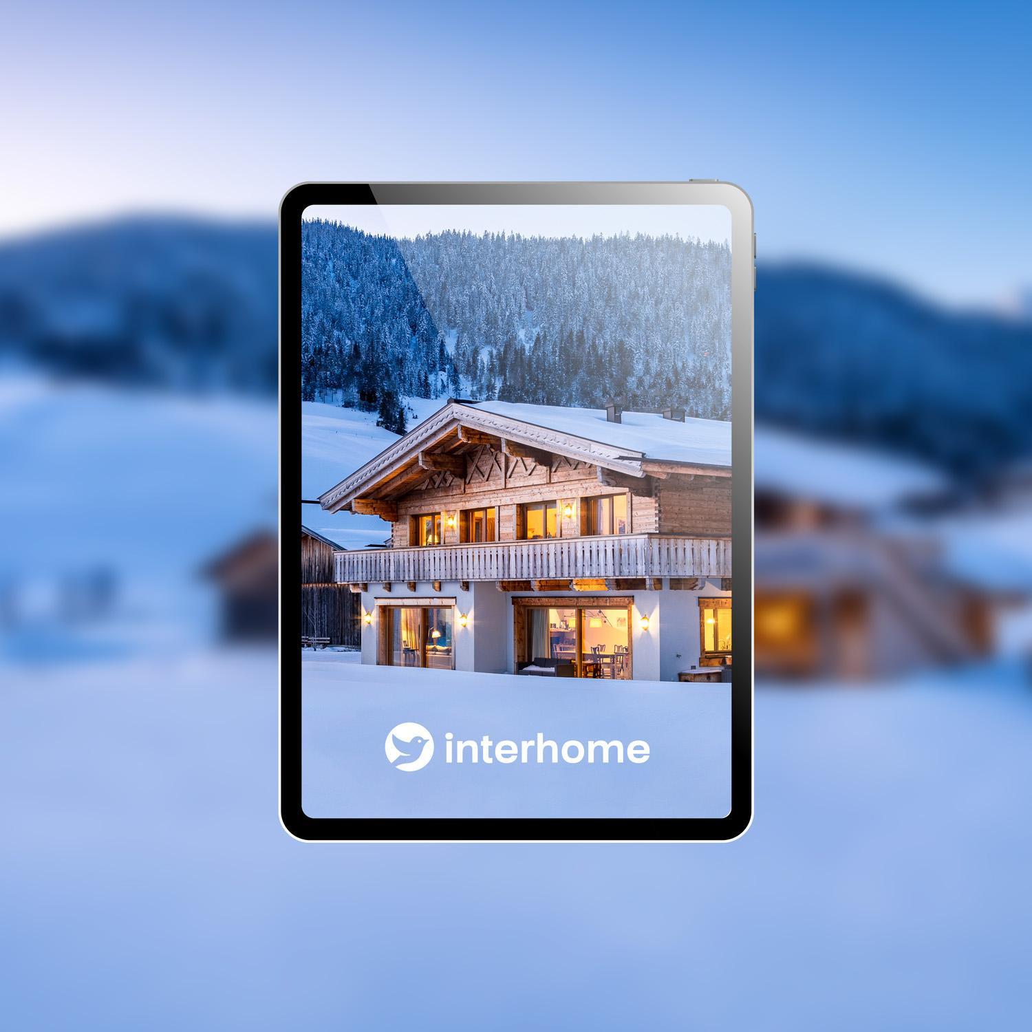 Tablet prikazuje oglas za Interhome chalet, predstavlja partnersku integraciju.